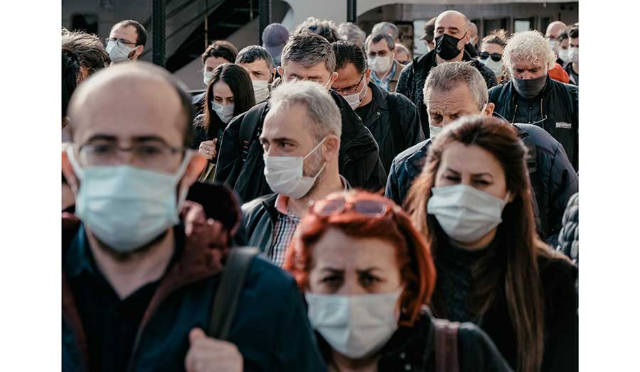 a crowd of people wearing masks